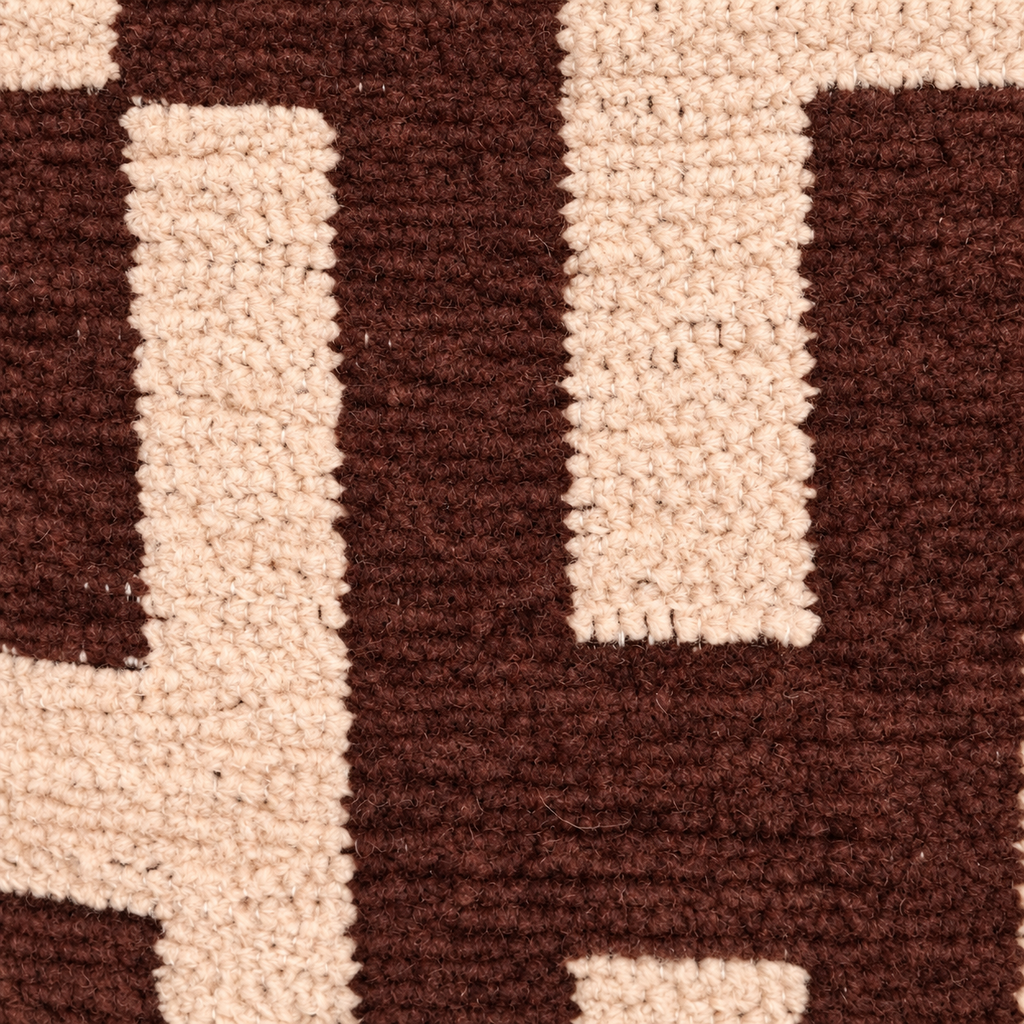 Detail van de bruine en crème geweven stof met geometrisch patroon